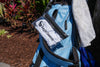 Blue golf bag with a towel and EagleSleeve product in a natural setting
