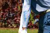 Person wearing a white arm sleeve with 'EagleSleeve' logo on a blurred outdoor background